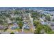 An aerial view highlights a house nestled among mature trees in a charming neighborhood near the waterfront at 1631 27Th Ave. N, North Myrtle Beach, SC 29582