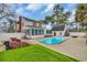 Backyard with in-ground pool, well-manicured lawn and detached garage with outdoor stair access at 1631 27Th Ave. N, North Myrtle Beach, SC 29582