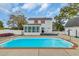Backyard features in-ground pool surrounded by concrete and a sunroom attached to the house at 1631 27Th Ave. N, North Myrtle Beach, SC 29582