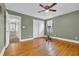 Bright bedroom featuring hardwood floors and ceiling fan with a large closet for storage at 1631 27Th Ave. N, North Myrtle Beach, SC 29582