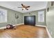 Bright bedroom featuring hardwood floors, ceiling fan, and an exercise machine for in-home fitness at 1631 27Th Ave. N, North Myrtle Beach, SC 29582