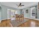 Charming dining area features a ceiling fan, a glass top table set on a plush rug, and a sunroom view at 1631 27Th Ave. N, North Myrtle Beach, SC 29582
