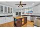 Well-lit kitchen featuring white cabinets, a central island, and stainless steel appliances at 1631 27Th Ave. N, North Myrtle Beach, SC 29582