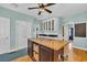 Airy kitchen featuring wood flooring, center island, and blue accent walls at 1631 27Th Ave. N, North Myrtle Beach, SC 29582