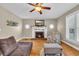 Cozy living room featuring hardwood floors, a fireplace, and large windows at 1631 27Th Ave. N, North Myrtle Beach, SC 29582