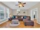 Bright living room with hardwood floors, large sectional couch, and ample natural light at 1631 27Th Ave. N, North Myrtle Beach, SC 29582