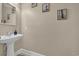 Simple powder room featuring pedestal sink, large mirror, and beach themed artwork at 1631 27Th Ave. N, North Myrtle Beach, SC 29582
