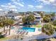 Aerial view showcasing a home with a pool, lush landscaping, and nearby beach access at 1644 South Waccamaw Dr., Murrells Inlet, SC 29576