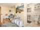Bright bedroom with an attached bathroom, neutral walls, and wooden flooring at 1644 South Waccamaw Dr., Murrells Inlet, SC 29576