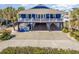Charming blue coastal home with a spacious front porch and ground-level parking at 1644 South Waccamaw Dr., Murrells Inlet, SC 29576