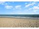 Scenic view of the sandy beach meeting the ocean under a clear blue sky with fluffy clouds at 2001 S Ocean Blvd. # 1505, Myrtle Beach, SC 29577