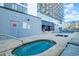 Relaxing outdoor hot tub near building with pool access and lounge seating at 2001 S Ocean Blvd. # 1505, Myrtle Beach, SC 29577