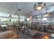 Inviting restaurant interior featuring multiple tables, chairs, TVs, and a fully stocked bar at 2001 S Ocean Blvd. # 1505, Myrtle Beach, SC 29577
