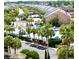 Scenic aerial view of a community pool, lush palm trees, and well-maintained resort buildings and landscaping at 218 Double Eagle Dr., Surfside Beach, SC 29575