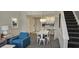 Open-concept living area with stylish furnishings, a dining table, and stairs to the upper level at 218 Double Eagle Dr., Surfside Beach, SC 29575