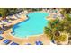 Beautiful outdoor pool area with turquoise water, surrounded by palm trees and comfortable lounge chairs at 218 Double Eagle Dr., Surfside Beach, SC 29575
