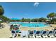 Inviting outdoor pool surrounded by lush palm trees and lounge chairs creating a relaxing resort atmosphere at 218 Double Eagle Dr., Surfside Beach, SC 29575