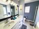 The bathroom features double sinks, granite countertops, framed mirror, plus bath and shower at 221 Black Bear Rd., Myrtle Beach, SC 29588
