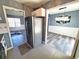 Open kitchen view with stainless steel refrigerator and entrances to the living and dining rooms at 221 Black Bear Rd., Myrtle Beach, SC 29588
