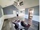 Open living room with gray walls, white wainscoting, wood-look floors, and access to other rooms at 221 Black Bear Rd., Myrtle Beach, SC 29588
