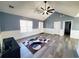 Inviting living room boasts a modern ceiling fan, gray wood-look floors, and a patterned rug at 221 Black Bear Rd., Myrtle Beach, SC 29588