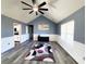 Bright living room features vaulted ceiling, gray walls, modern rug, and a ceiling fan at 221 Black Bear Rd., Myrtle Beach, SC 29588