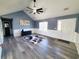 Bright living room features vaulted ceilings, modern fan, wood-look floors, and contemporary wainscoting at 221 Black Bear Rd., Myrtle Beach, SC 29588
