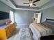 Inviting main bedroom boasts a ceiling fan, dresser, plank flooring and plenty of room at 221 Black Bear Rd., Myrtle Beach, SC 29588