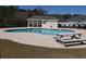 Community pool with a cabana, surrounded by a fence and landscaping, offering a relaxing recreational space at 221 Black Bear Rd., Myrtle Beach, SC 29588
