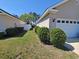Clean side yard features healthy lawn, shrubbery, and a white fence for added privacy at 221 Black Bear Rd., Myrtle Beach, SC 29588