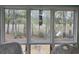 Backyard view from inside the home, showcasing the serene environment with lovely trees at 2240 Jackson Circle, Little River, SC 29566