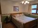 Cozy bedroom featuring a queen-sized bed with a floral comforter, complemented by a ceiling fan and natural light at 2240 Jackson Circle, Little River, SC 29566