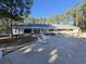 Exterior shot of community building with a paved patio and several lounge chairs for relaxing outside at 2240 Jackson Circle, Little River, SC 29566