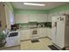 Bright kitchen with white cabinets, granite countertops, modern appliances, and neutral tile flooring at 2240 Jackson Circle, Little River, SC 29566