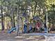 Community playground featuring climbing structures, slides, and swing sets surrounded by trees at 2240 Jackson Circle, Little River, SC 29566