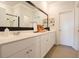 Bright bathroom featuring double vanity, ample storage, neutral countertop and a large framed mirror at 228 Carolina Lakes Blvd., Myrtle Beach, SC 29588