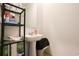A bathroom with a pedestal sink and metal shelving stocked with paper towels and various cleaning supplies at 228 Carolina Lakes Blvd., Myrtle Beach, SC 29588