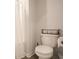 Bright bathroom featuring a toilet with a toilet paper holder and a roll paper storage basket on top at 228 Carolina Lakes Blvd., Myrtle Beach, SC 29588