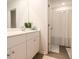 Bright bathroom featuring a large mirror over the sink and a white shower curtain near the shower at 228 Carolina Lakes Blvd., Myrtle Beach, SC 29588