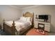 Cozy bedroom with a large bed, patterned bedding, and a makeup table with a mirror and stool at 228 Carolina Lakes Blvd., Myrtle Beach, SC 29588