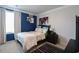 Nicely decorated bedroom with a blue accent wall, large window and striped rug at 228 Carolina Lakes Blvd., Myrtle Beach, SC 29588