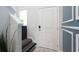 Charming entryway with a white door, decorative molding, patterned stairs, and green plants at 228 Carolina Lakes Blvd., Myrtle Beach, SC 29588