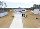 Two-story home features a large driveway, attached garage, and landscaped front yard at 228 Carolina Lakes Blvd., Myrtle Beach, SC 29588