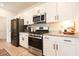 Modern kitchen with white cabinets, granite countertops, and stainless steel appliances at 228 Carolina Lakes Blvd., Myrtle Beach, SC 29588
