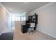 A spacious office with a black desk, computer, and chairs, illuminated by natural light from a nearby window at 228 Carolina Lakes Blvd., Myrtle Beach, SC 29588