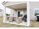 Covered back patio with cozy seating and a gas grill, perfect for outdoor entertaining at 228 Carolina Lakes Blvd., Myrtle Beach, SC 29588