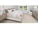Bright bedroom with a large bed, bedside tables, and a serene view at 2404 Watershed Way, Longs, SC 29568