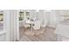 Bright dining area featuring a white table set for six in an elegant space at 2404 Watershed Way, Longs, SC 29568
