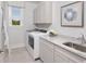 Bright laundry room featuring modern appliances, ample counter space, and natural light at 2404 Watershed Way, Longs, SC 29568