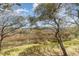 Enjoy a marsh view from the backyard bordered with mature trees and shadow dappled grass at 276 Salt Marsh Circle # 4D, Pawleys Island, SC 29585
